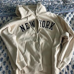 Brandy Melville Cream Hoodie with Black Lettering